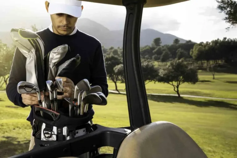 Un homme sur la pelouse met des clubs de Gold dans son sac